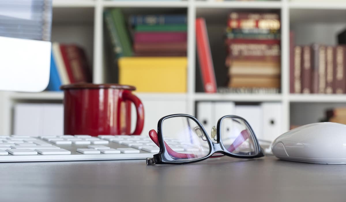 A pair of glasses sitting on a desk