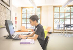 Young boy concentrating at a library