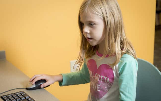 Young girl using the computer in the computer lab