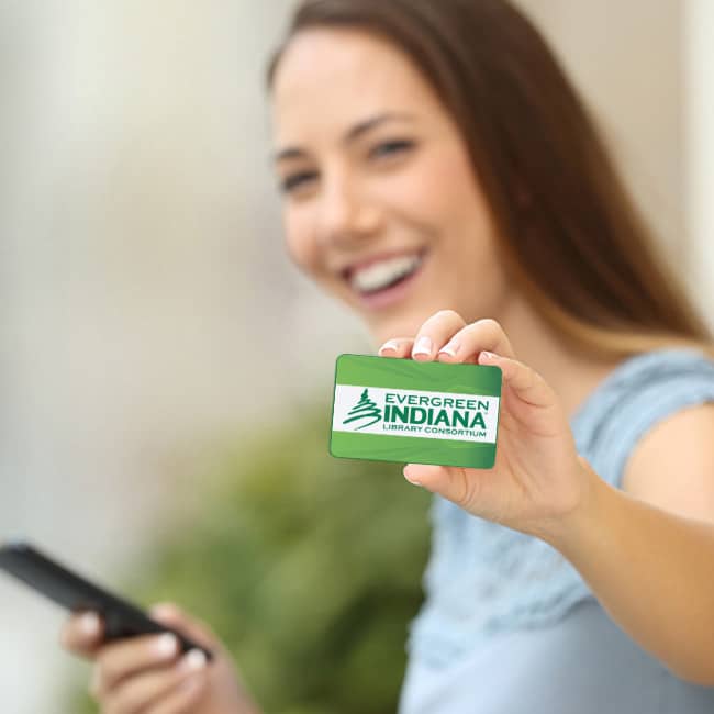 Woman holding an Evergreen Indiana card smiling