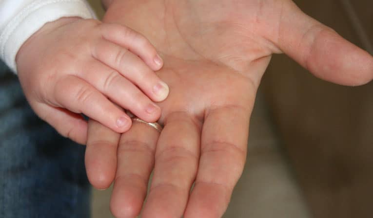 Child's hand holding an adult hand