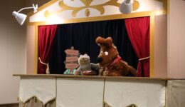 Dog and chipmunk puppets on puppet stage