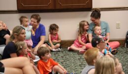 Children and caregivers watching a puppet show