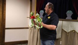 Man with two frog puppets