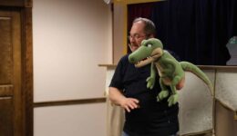 Man holding alligator puppet