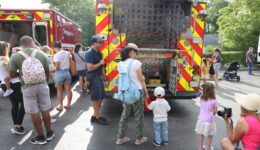 Caregivers and children looking at fire truck