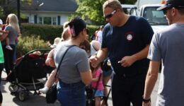 Firefighter hand sticker to child and caregiver