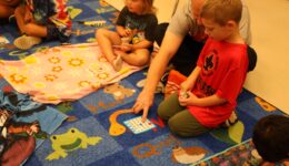 Kids and caregiver playing Bingo