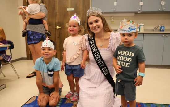 Miss Boone County with children after storytime
