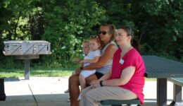 Caregivers and children listening to a story at the park