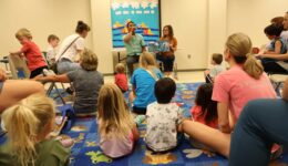 Children and caregivers listening to ASL storytime