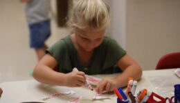 Child working on a craft during ASL storytime