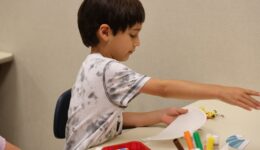 Child working on a craft during ASL storytime