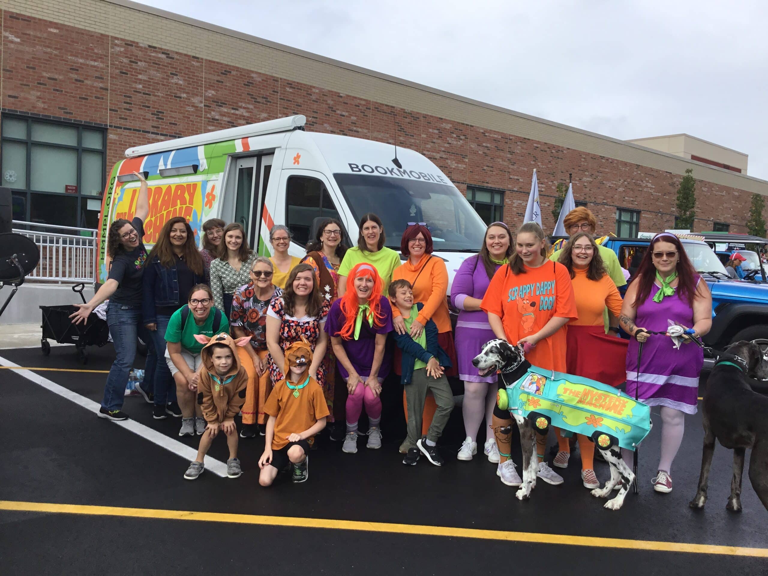 Library staff dressed up at the Scooby Doo gang, with the Bookmobile transformed into the Library Machine (like Mystery Machine from Scooby Doo)