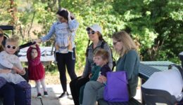 Children and caregivers at the Elm Street Green StoryWalk