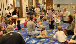 Librarians, caregivers and children at the Romp & Stomp program