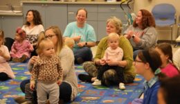 Caregivers and children at the Romp & Stomp program