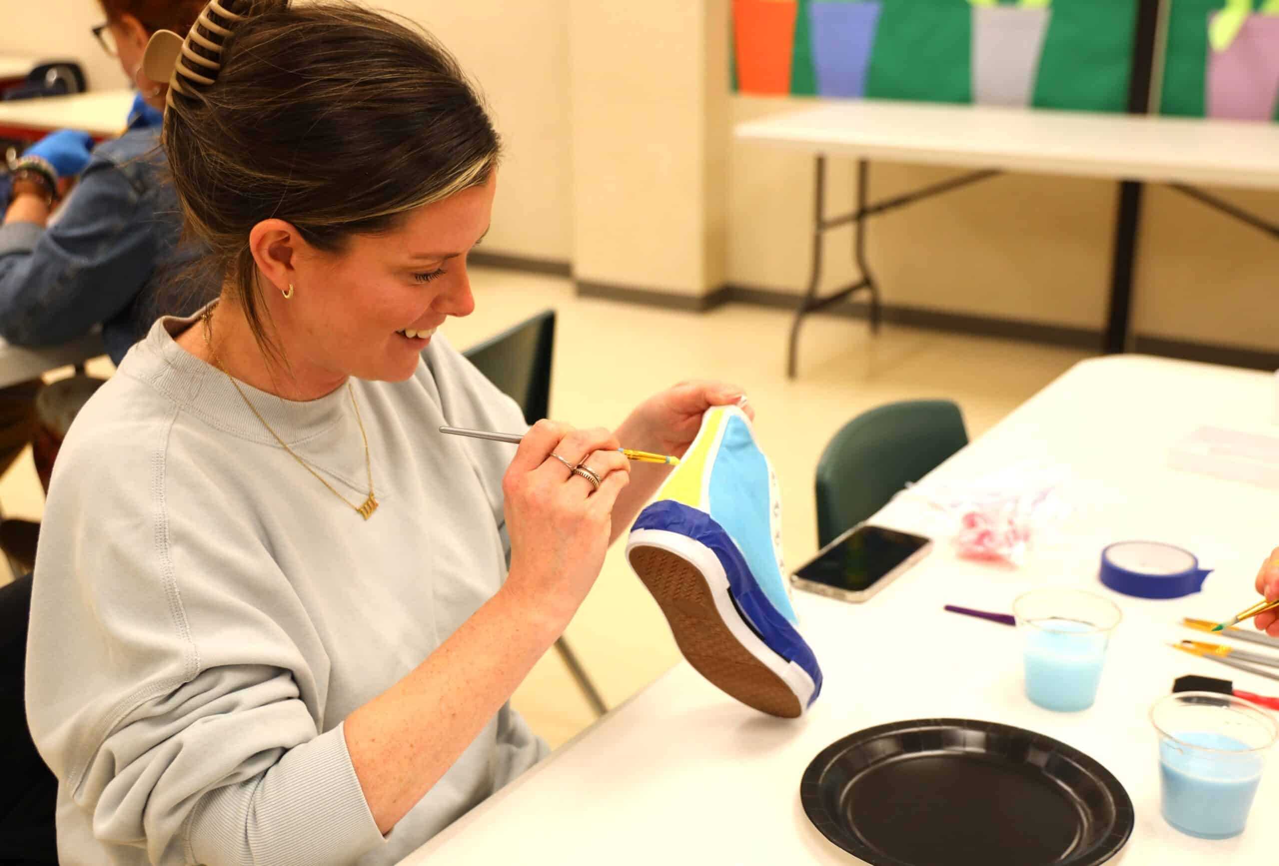 Woman painting a sneaker