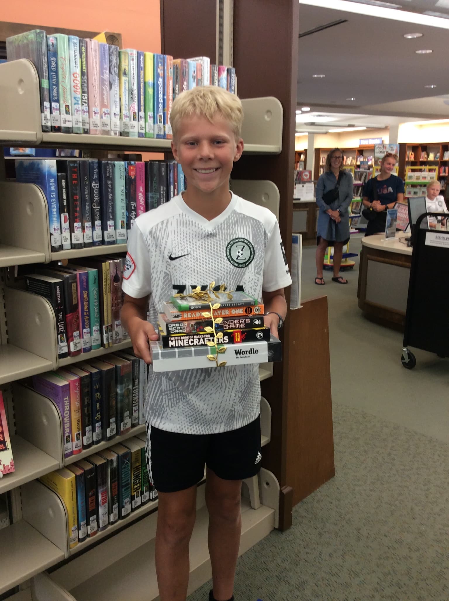Teen holding a stack of video games