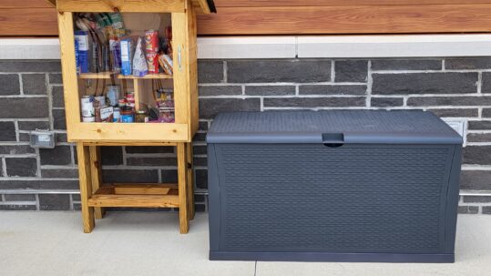 Little food pantry box with an adjacent large plastic storage box for paper supplies