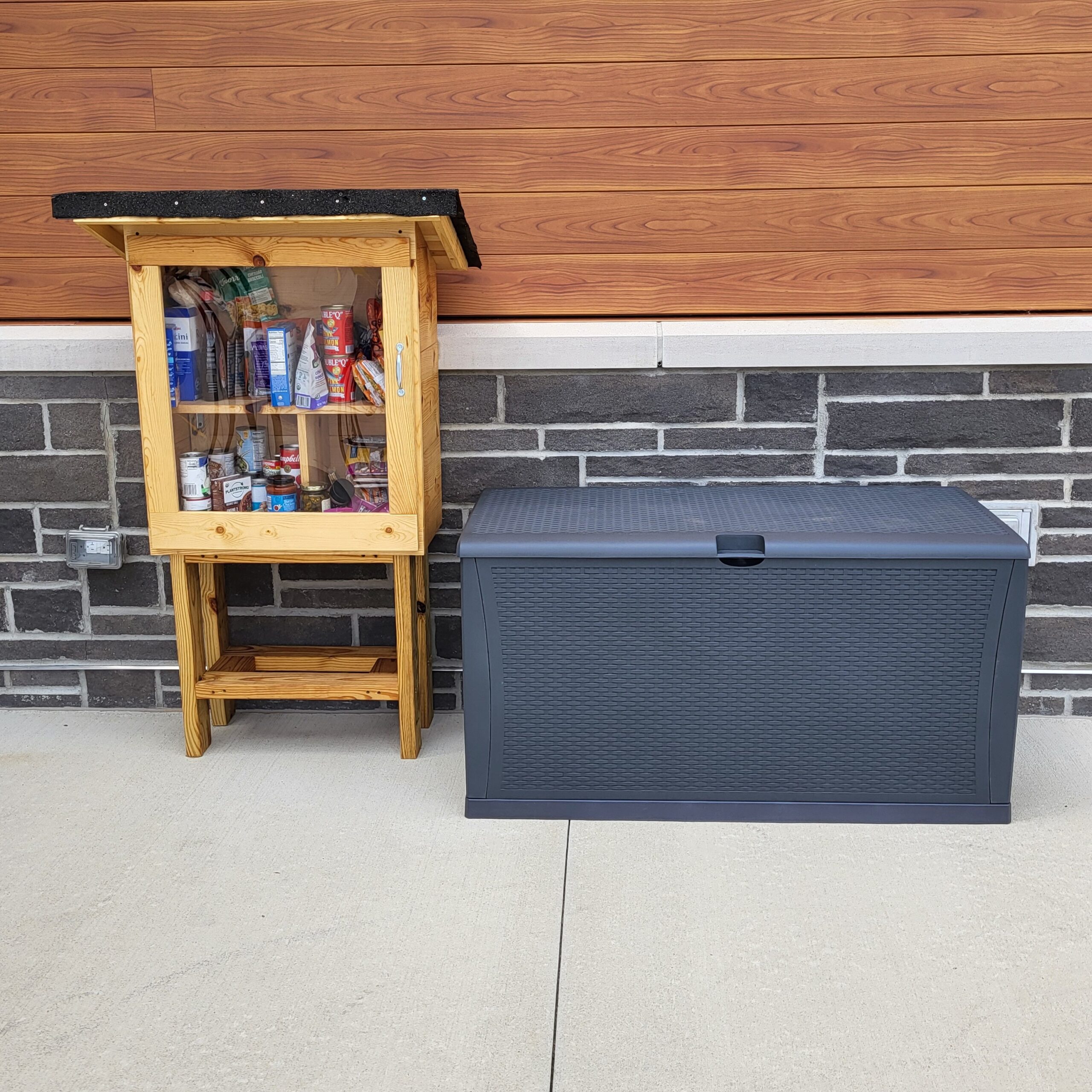 Little food pantry box with an adjacent large plastic storage box for paper supplies