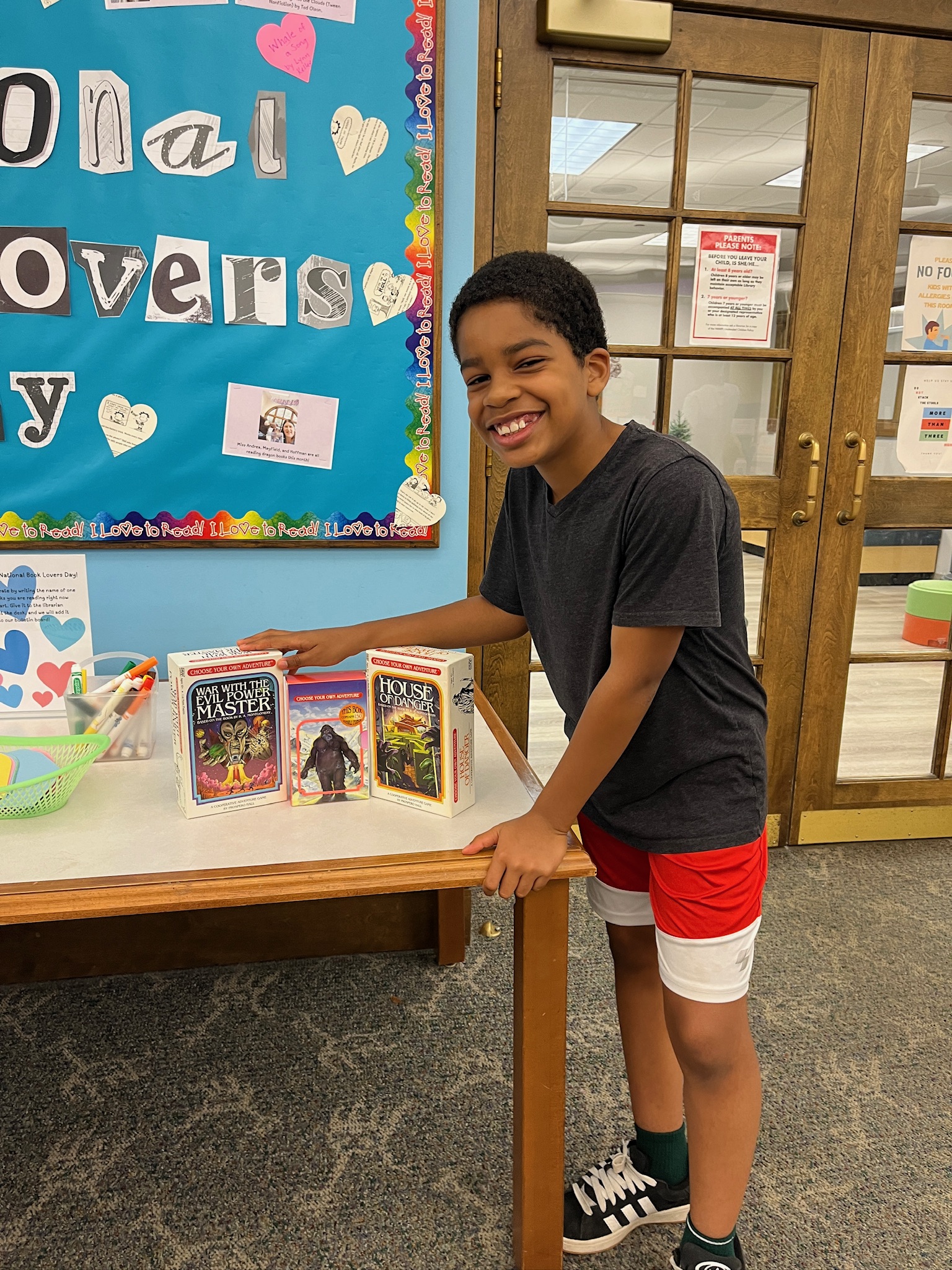youth showing off book collection prize
