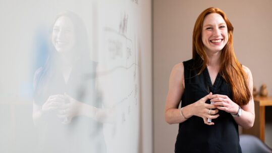 Female teacher in front of white board