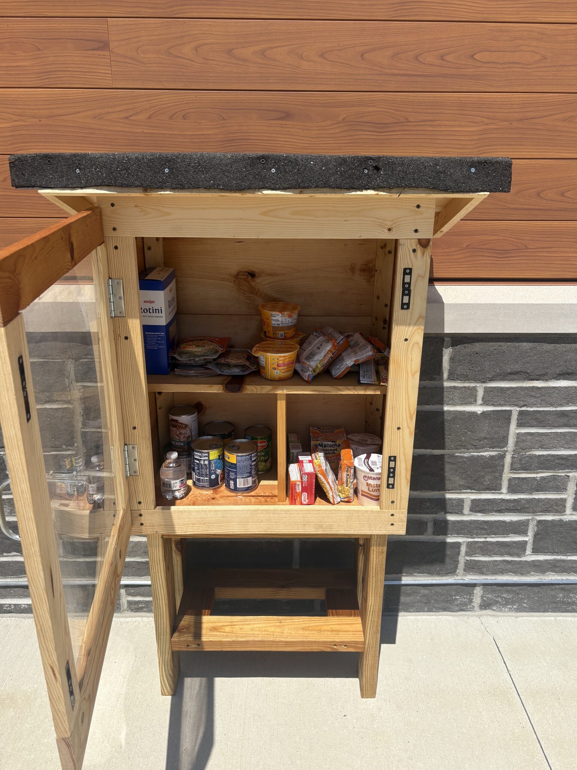 Photo of a little free pantry with the door open and food inside