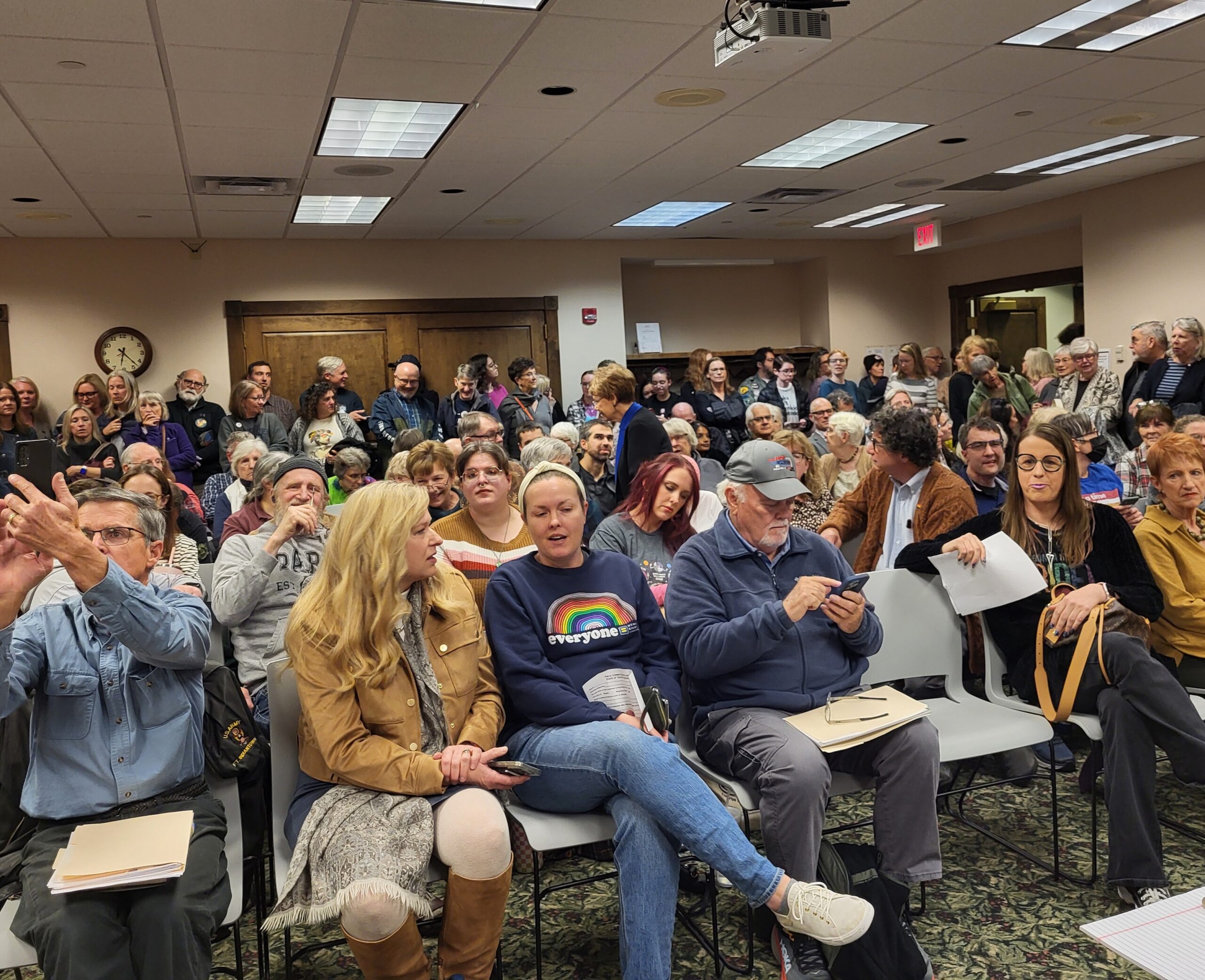 A room full of seated people at a library board meeting.